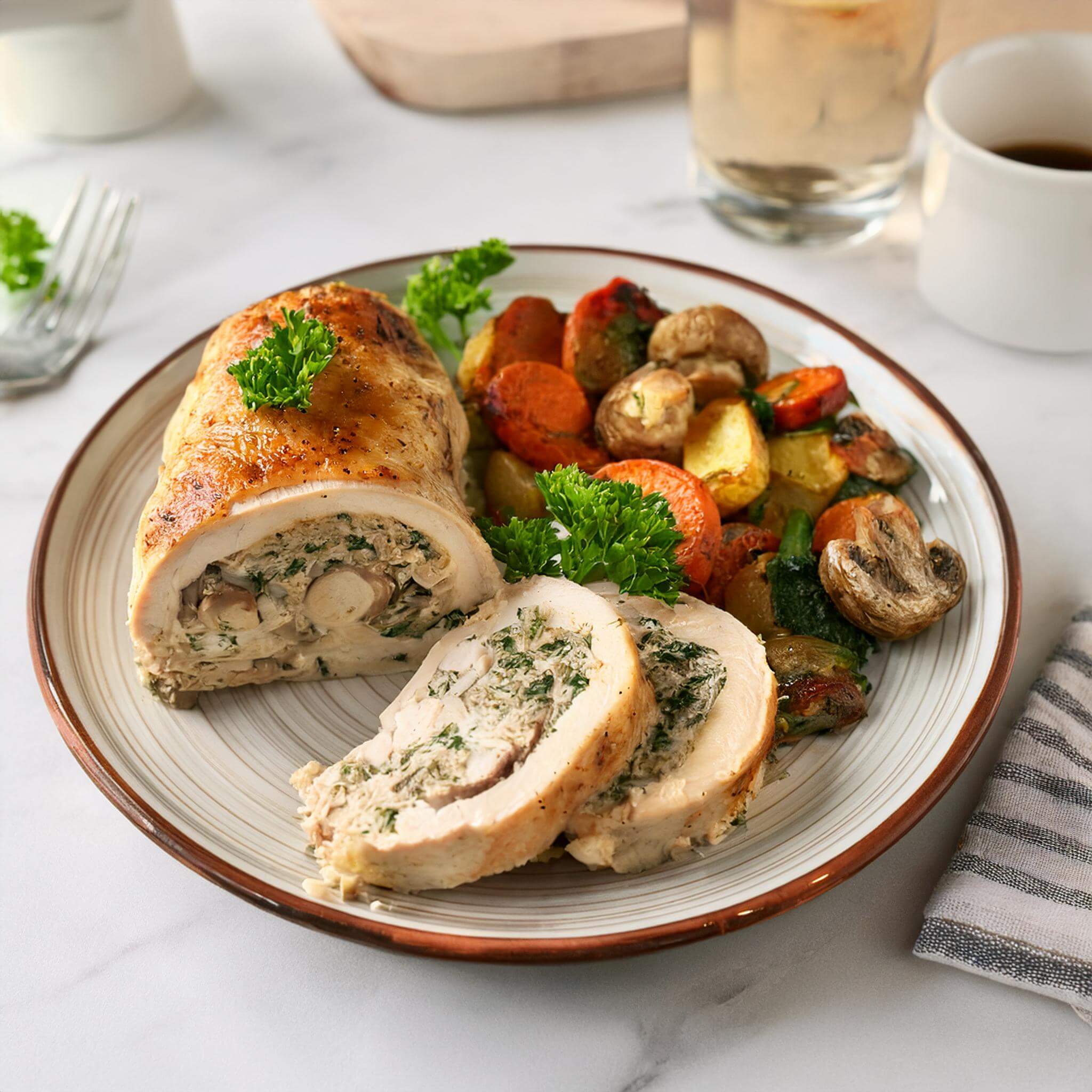 chicken with mushroom and spinach filling, garnished with parsley.