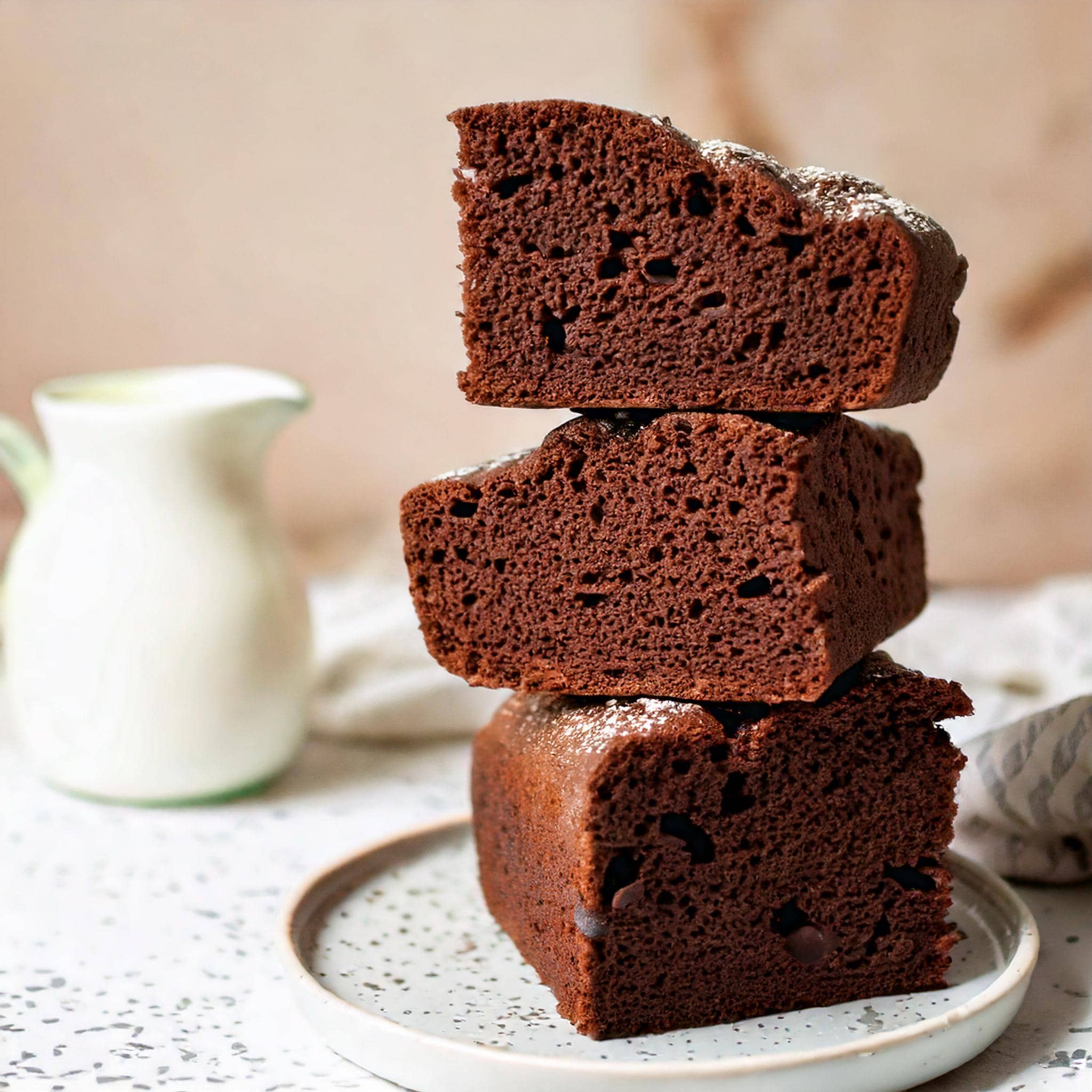 A knife slicing into a freshly baked Double Chocolate Focaccia on a wooden board, with a moist and chocolatey texture.