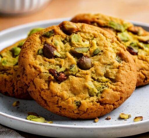 Close-up of a pistachio chocolate chip cookie highlighting its texture.