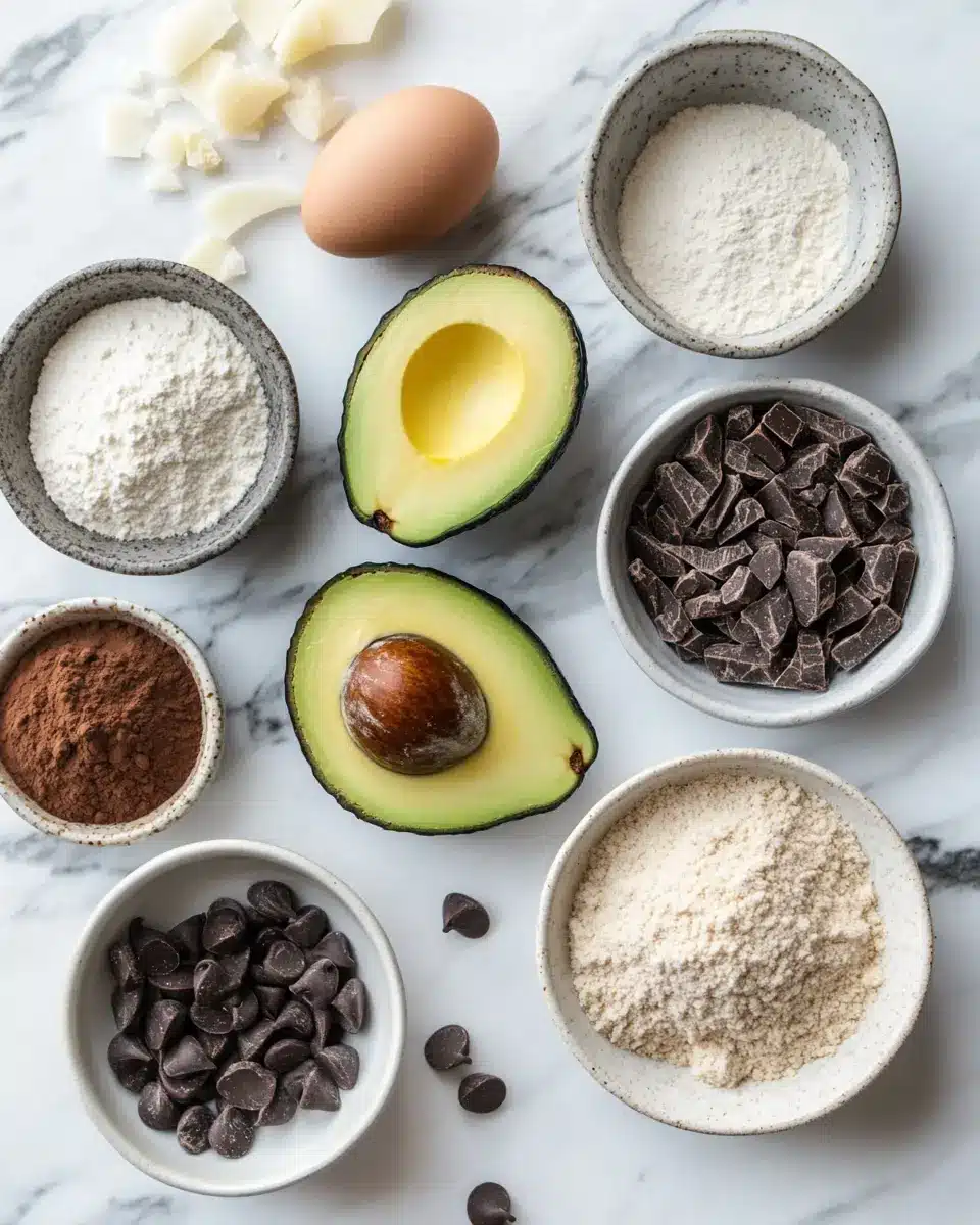 Flat lay of avocado brownie ingredients on a marble surface